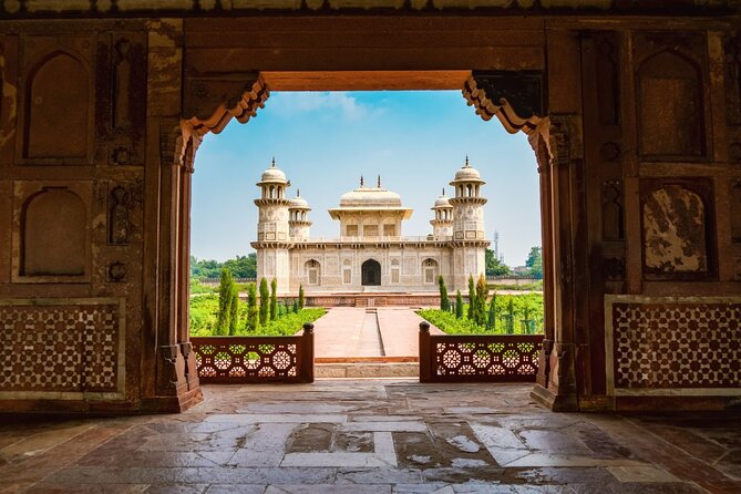 The Taj Mahal framed by a sandstone gateway at first light